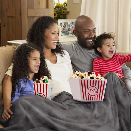 Family enjoying popcorn together during a cozy movie night