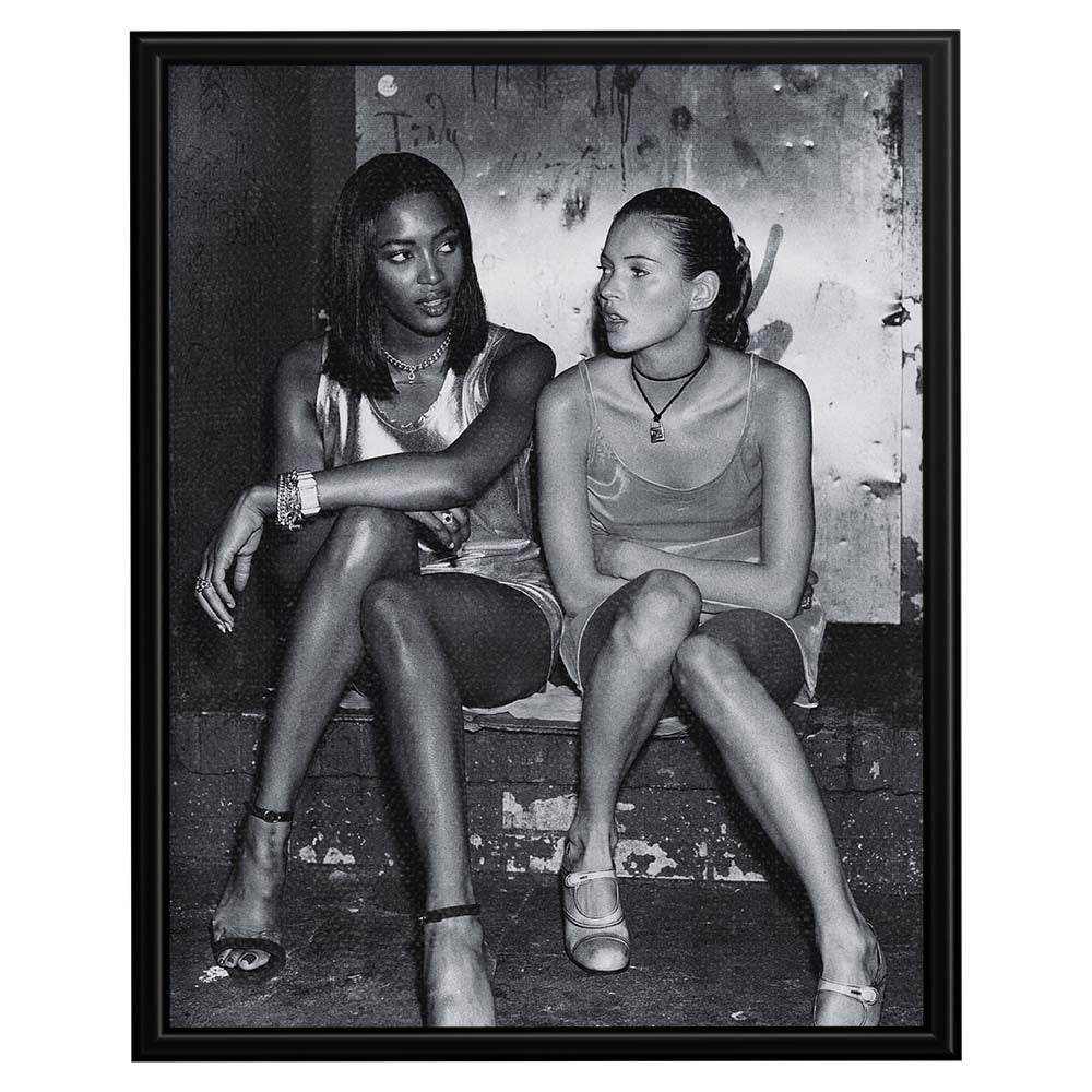 Wownic fashion icon poster featuring two models seated together in a candid black-and-white editorial portrait