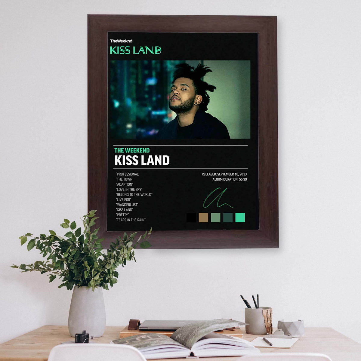 Wownic Kiss Land dark music wall art displayed as a framed poster above a modern desk