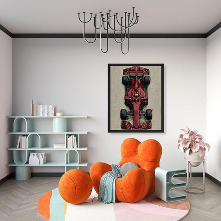 A framed wall art print of a red Formula 1 car is displayed in a modern living room setting above a chunky orange cloud-shaped armchair.