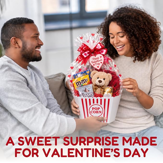 Couple exchanging a Wownic Valentine's movie night gift basket with teddy bear and candy